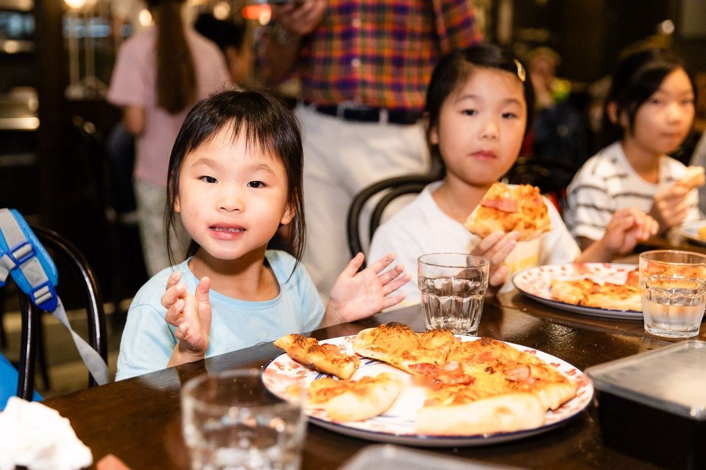 Kids eating the pizzas they made