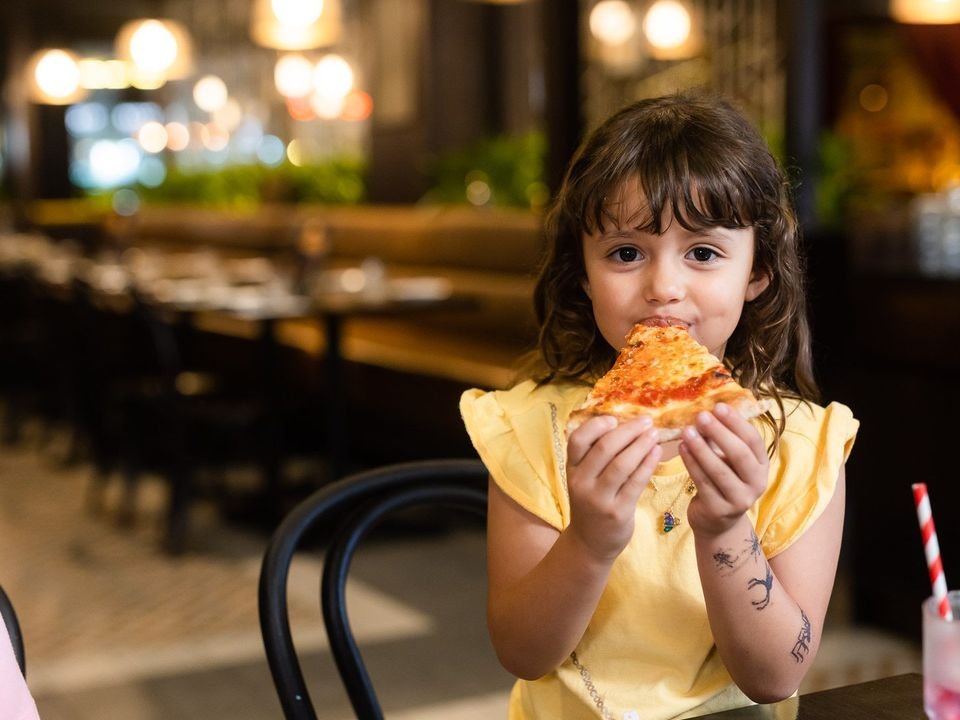 A child enjoying pizza at Belliney's